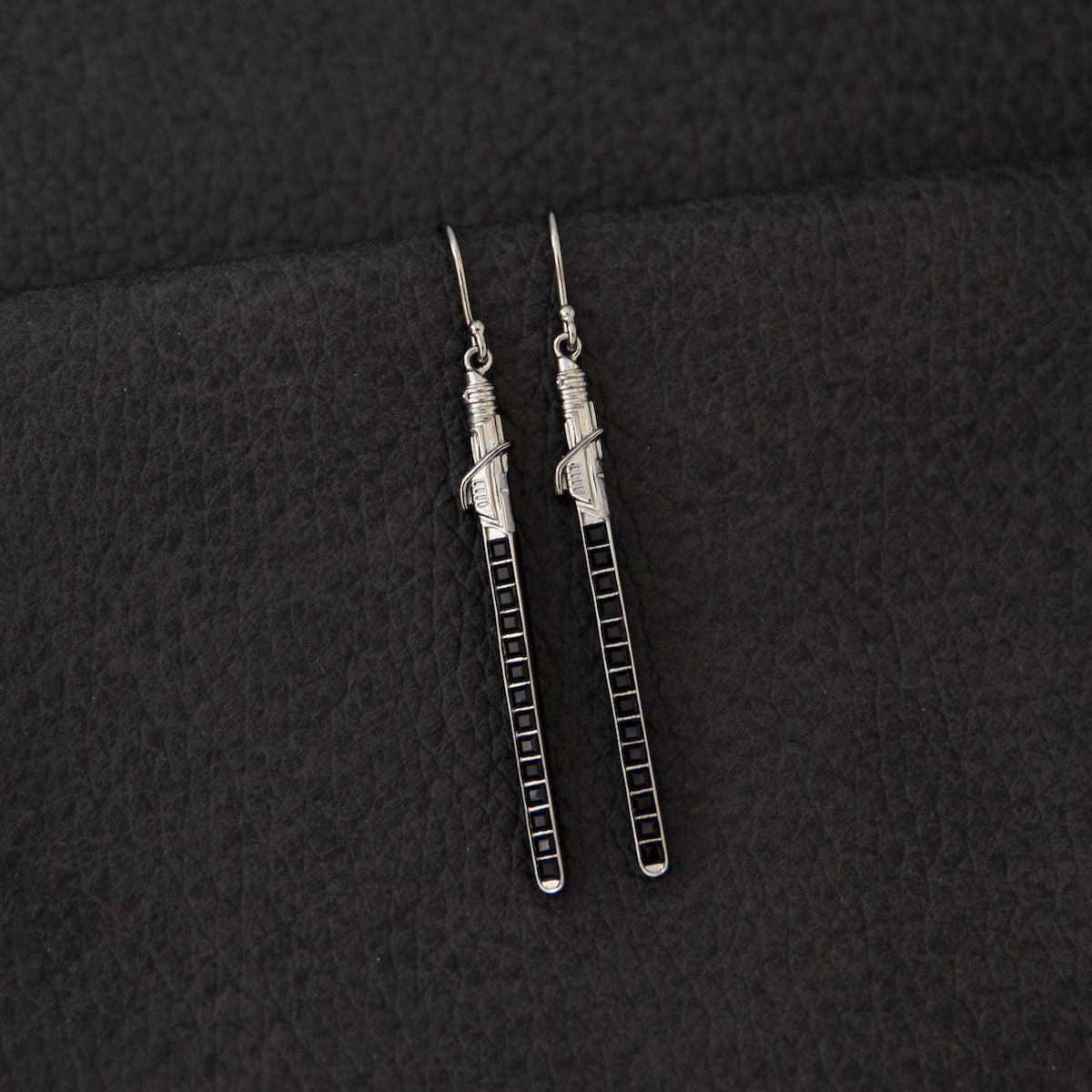 The Darksaber earrings displayed inside the branded Star Wars x RockLove Collector's Box.
