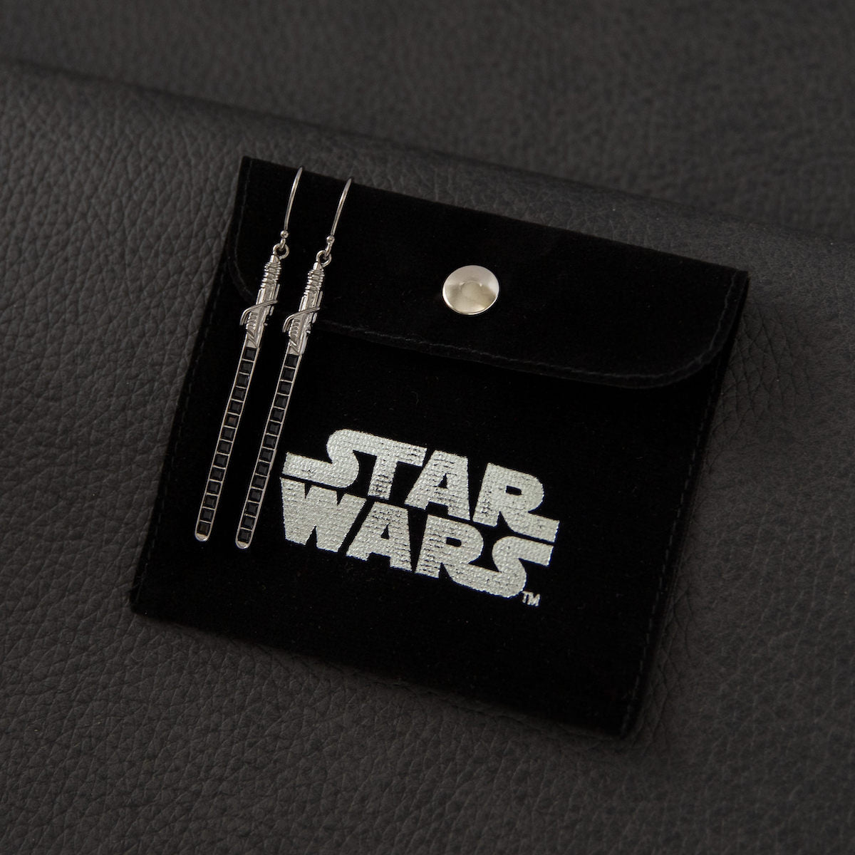 Profile view of the Darksaber earrings highlighting the sterling silver construction and French wire hooks.