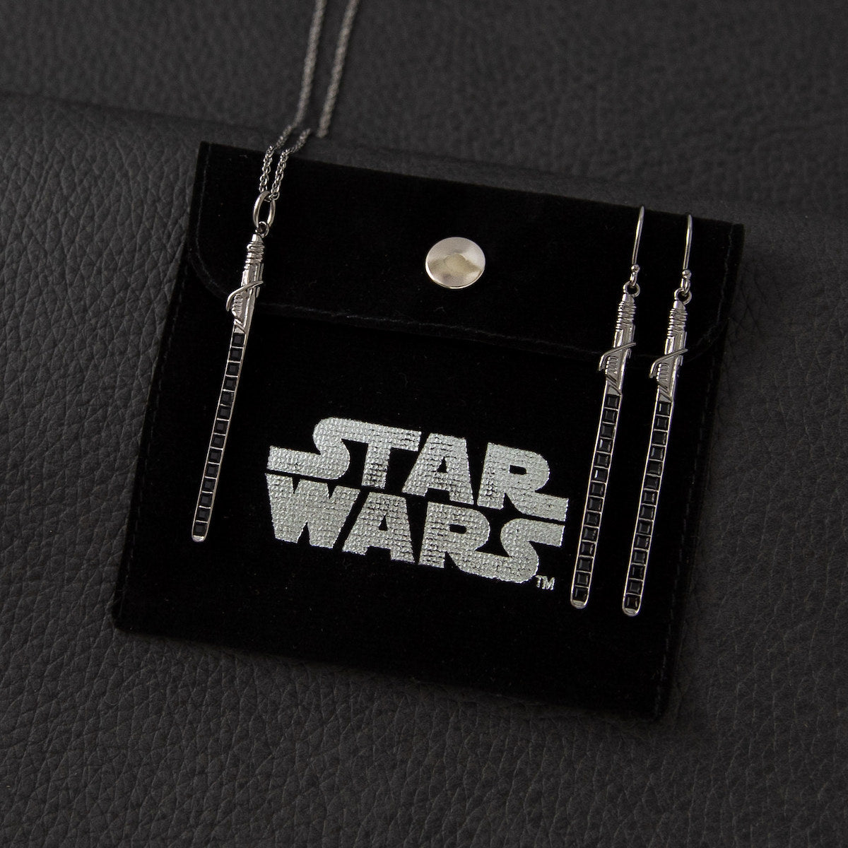 Scale shot of the Darksaber earrings showing the 65mm total drop length.