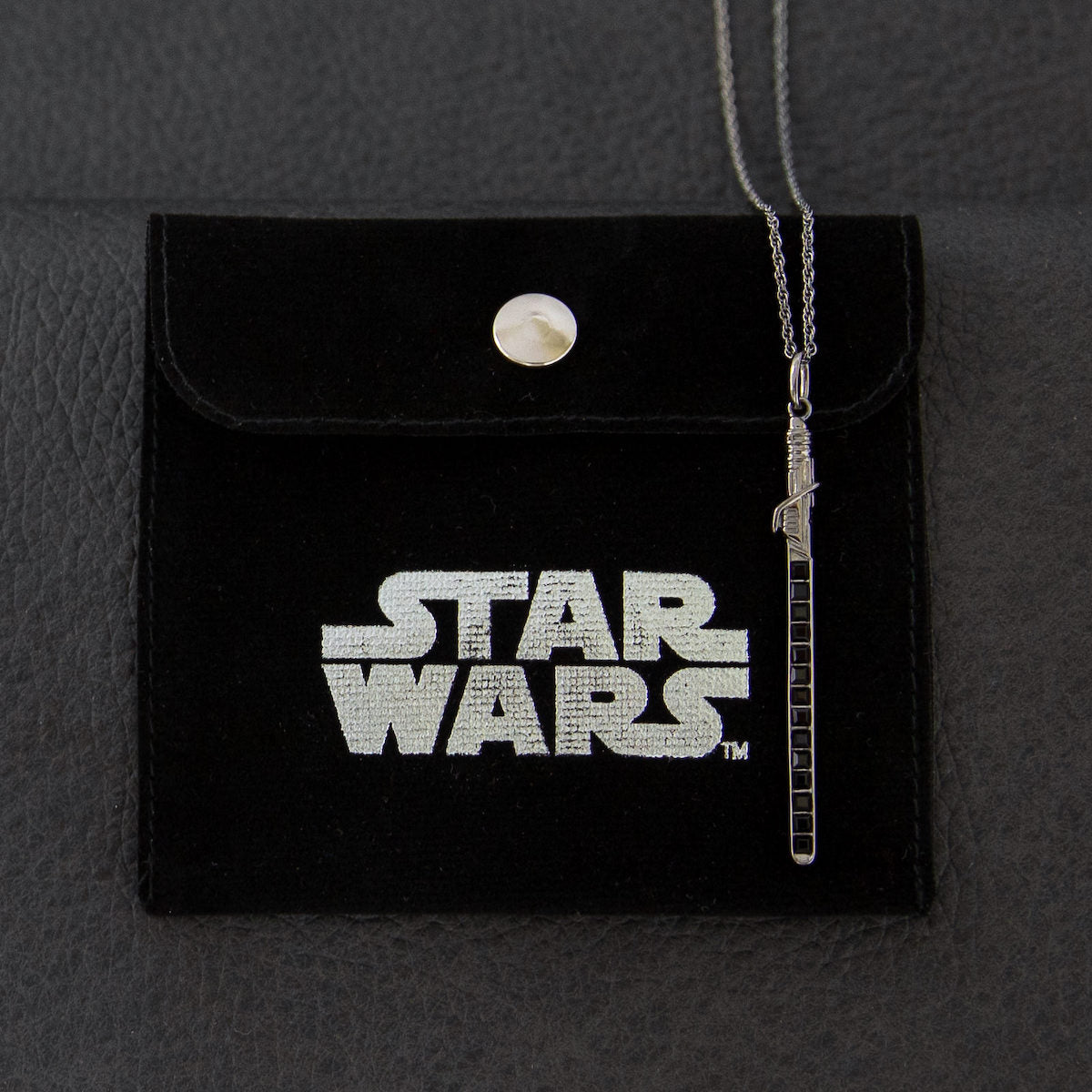 Detail shot of the Darksaber hilt and blade pendant.