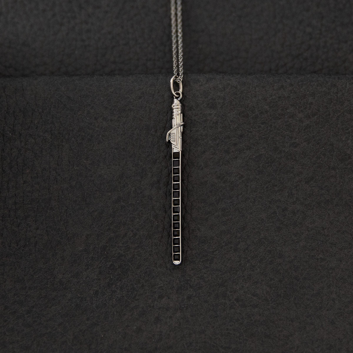Mandalorian Darksaber necklace with adjustable sterling silver chain.