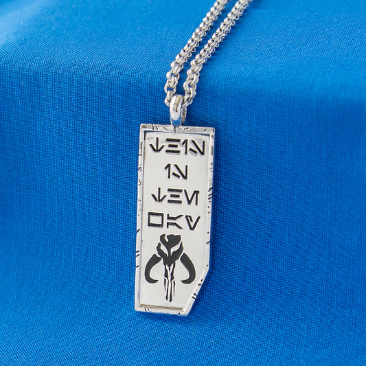 Close-up of Star Wars x RockLove This is the Way necklace showing Aurebesh engraving and Mythosaur symbol-3