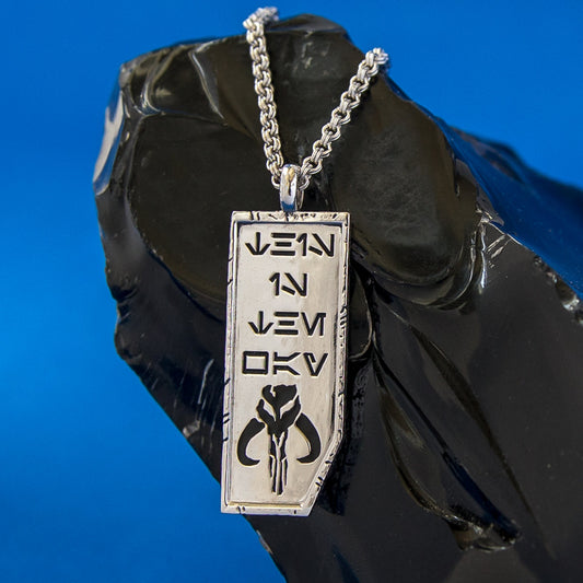 Close-up of Star Wars x RockLove This is the Way necklace showing Aurebesh engraving and Mythosaur symbol-4